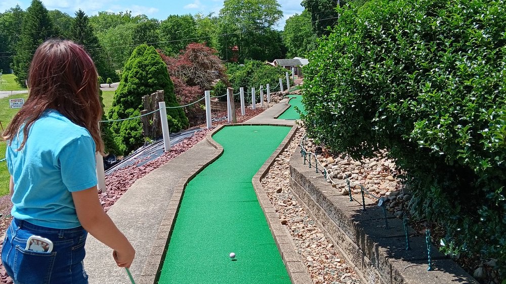 Woman playing mini golf at Mister C's Funspot